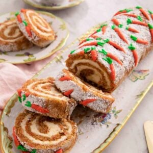 A close up of a carrot cake roll cut into slices