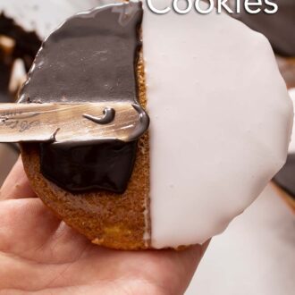 Pinterest graphic of a black and white cookie being iced with chocolate icing.