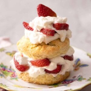 A strawberry shortcake on a plate with colorful butterflies.