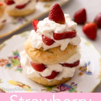 Pinterest graphic of a plate of strawberry shortcake topped with cream and sliced berries.