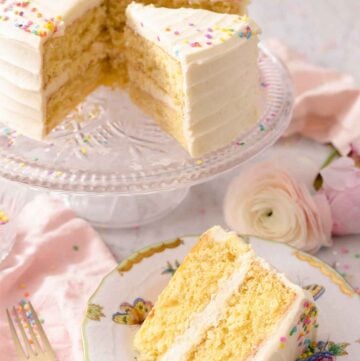 A slice of vanilla cake on a plate in front of the cake on a cake stand.