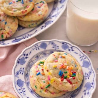 Pinterest graphic of of two plates of funfetti cookies beside a glass of milk.