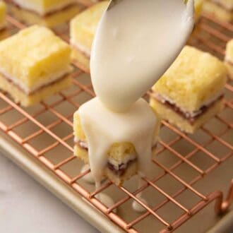 Pinterest graphic of petit fours being frosted with a spoonful of frosting.