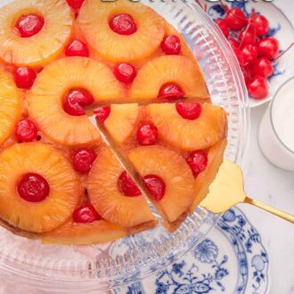 Pinterest graphic of a pineapple upside down cake with a cut slice being lifted,