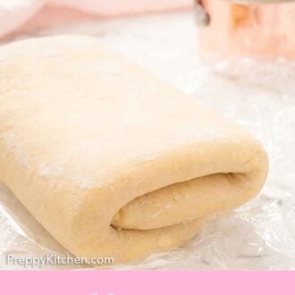 Pinterest graphic of unbaked puff pastry dough, folded, with a measuring cup beside it.