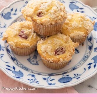 Pinterest image of a plate of five raspberry muffins with one sitting on top of the four.