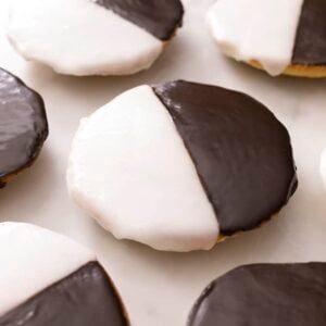 Black and white cookies on a marble surface.