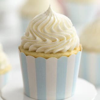 A closeup of a cupcake frosted with buttercream frosting