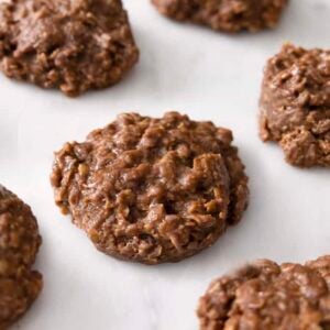 Chocolate peanut butter no bake bookies on a marble surface.