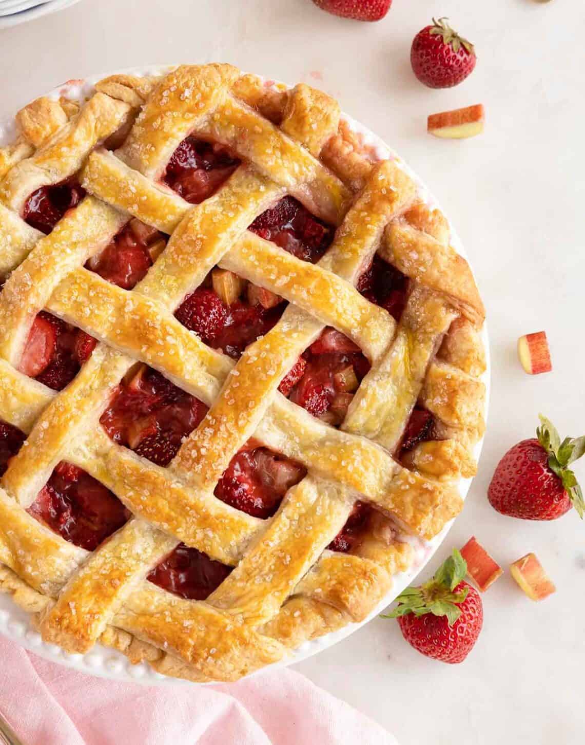 Overhead view of a strawberry rhubarb pie with a grid lattice.
