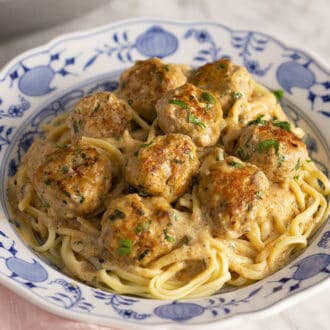 A bowl of Swedish Meatballs on a bed of linguini.