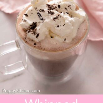 Pinterest graphic of a cup of hot chocolate with whipped cream and chocolate shavings.