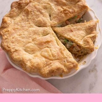 Pinterest graphic showing a chicken pot pie with slices cut out.