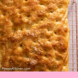 Pinterest graphic of a focaccia cooling on a wire rack.