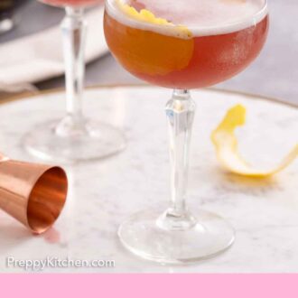 Pinterest graphic of two glasses of French martinis with lemon peel garnishes.
