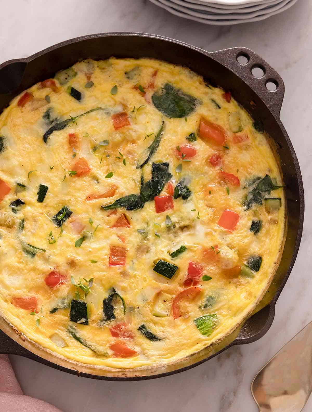 Overhead view of a cast iron pan containing a frittata.