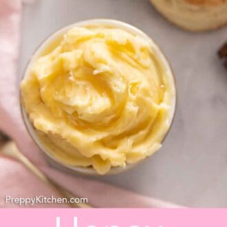Pinterest graphic of an overhead view of honey butter by a pink napkin and biscuits.