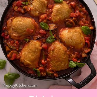 Pinterest graphic of an overhead view of a pan of chicken cacciatore with fresh basil on top.
