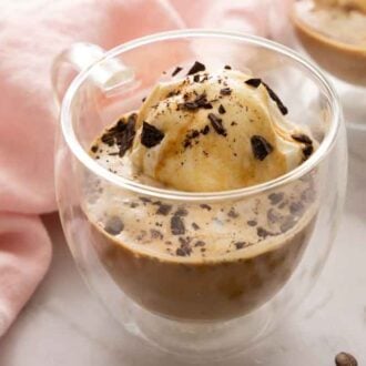 A cup of affogato with shaved chocolate on top.