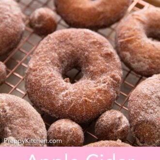 Pinterest graphic of apple cider donuts on a wire rack over a sheet pan.