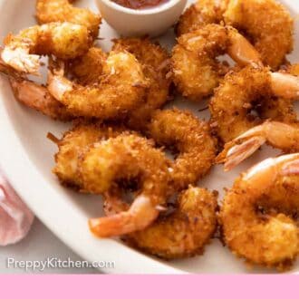 Pinterest graphic of a platter of coconut shrimp with a small bowl of dipping sauce.