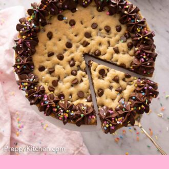 Pinterest graphic of a cookie cake with a slice cut out and slightly pulled forward.