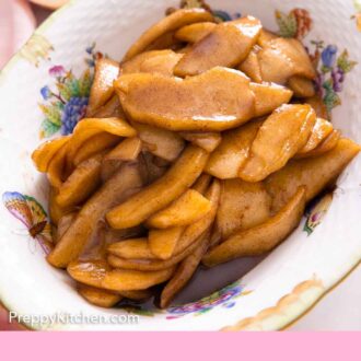 Pinterest graphic of a bowl of fried apples with cut apples in the background.