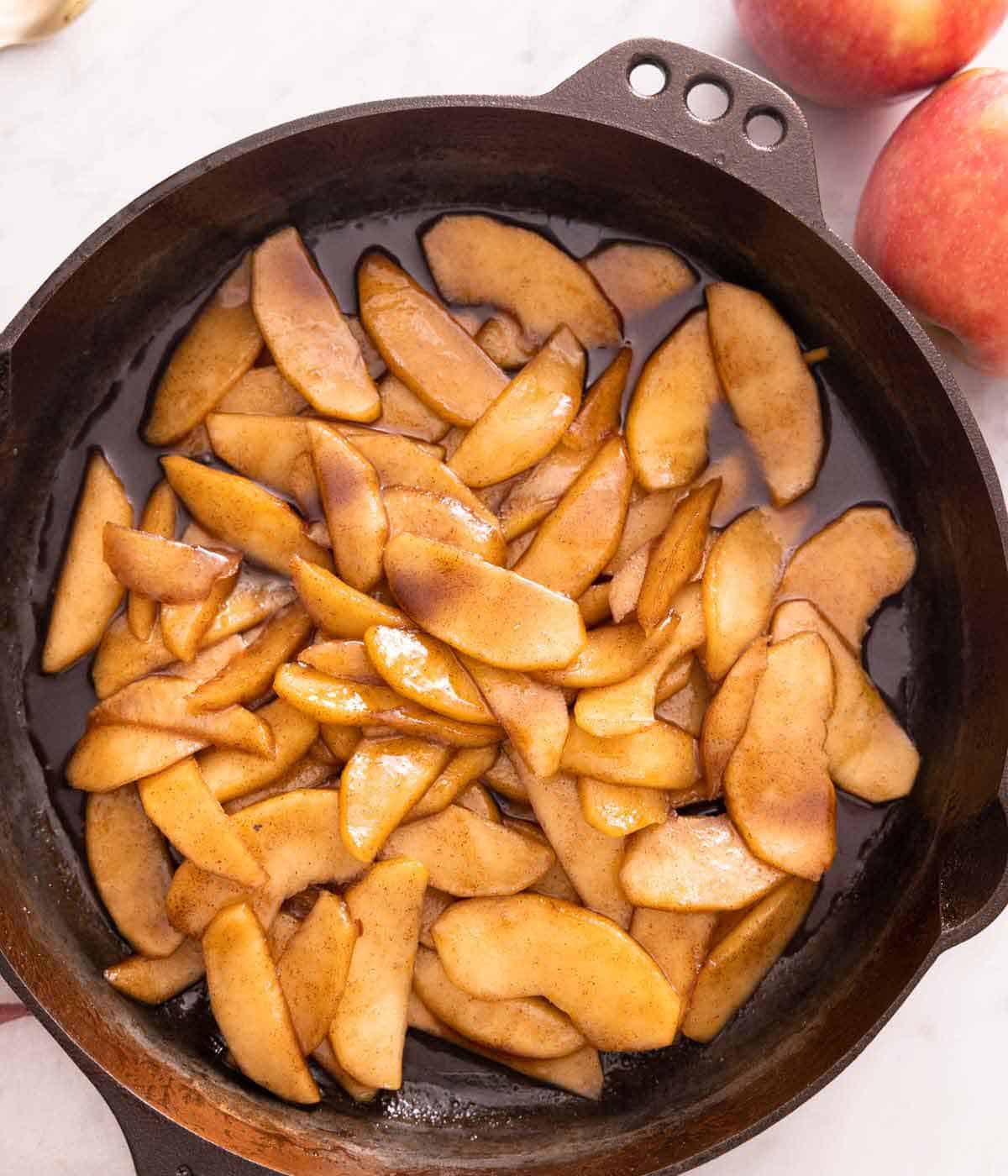 A cast iron pan with fried apples.