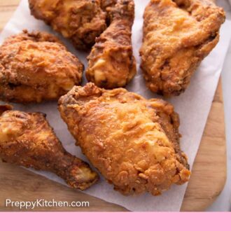 Pinterest graphic of six fried chicken on a paper towel on a cutting board.