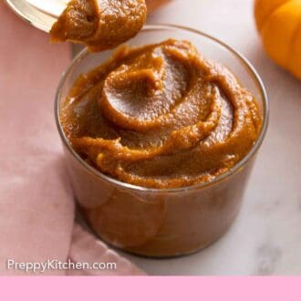 Pinterest graphic of a jar of pumpkin butter with a spoonful scooped out.