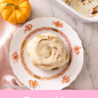 Pinterest graphic of an overhead view of a pumpkin cinnamon roll with cream cheese frosting.