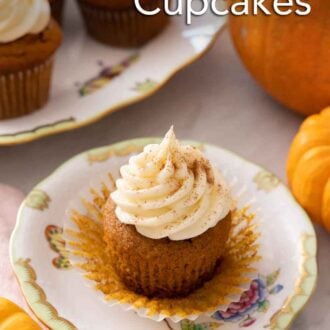 Pinterest graphic of a pumpkin cupcake with the liner pulled down on a plate in front of some pumpkins and cupcakes.
