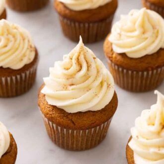 Pumpkin cupcakes with cream cheese frosting.