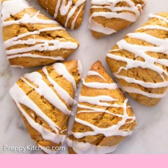 Pinterest graphic of six pumpkin scones on a marble counter.