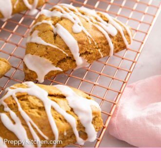 Pinterest graphic of pumpkin scones with glaze on top of a wire rack.