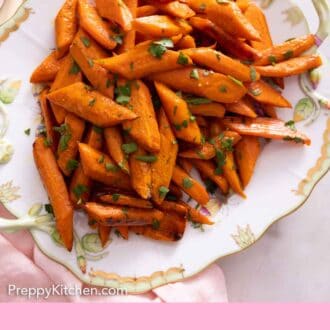 Pinterest graphic of a platter of roasted carrots garnished with parsley.