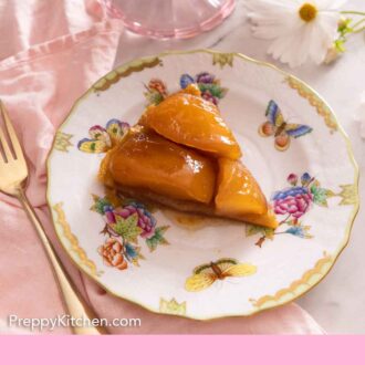 Pinterest graphic of a slice of tarte Tatin on a plate beside a pink linen napkin, a fork, and a daisy.