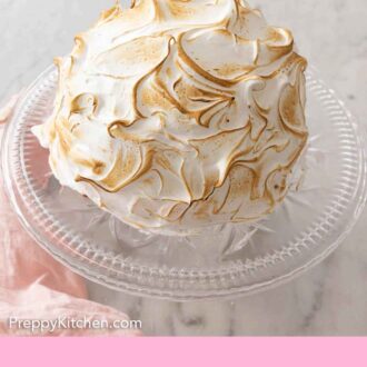 Pinterest graphic of a baked Alaska on a cake stand.