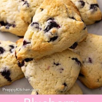 Pinterest graphic of a pile of blueberry scones stacked on top of each other.