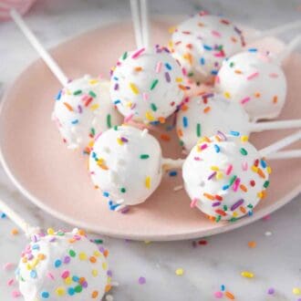 Pinterest graphic of a plate of cake pops with one placed in front.