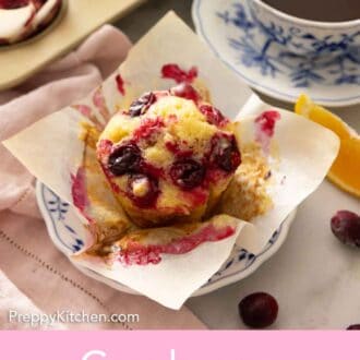 Pinterest graphic of a cranberry orange muffin with the liner pulled opened, on a plate.