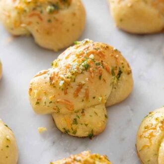 Multiple garlic knots on a counter top.