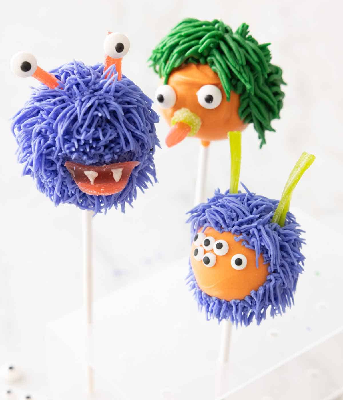 Three Halloween cake pops decorated as monsters.
