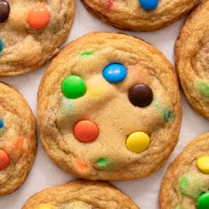 Colorful M&M Cookies on a white counter.