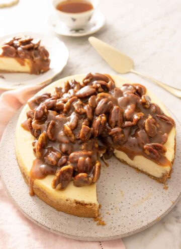 A pecan pie cheesecake with a slice taken out.