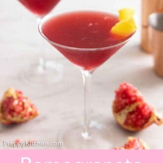 Pinterest graphic of two glasses of pomegranate martinis with a cocktail shaker in the back.