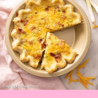 Pinterest graphic of a pie dish with a few slices of quiche cut.