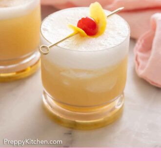 Pinterest graphic of glasses containing whiskey sours with lemon peel and a maraschino cherry on top.