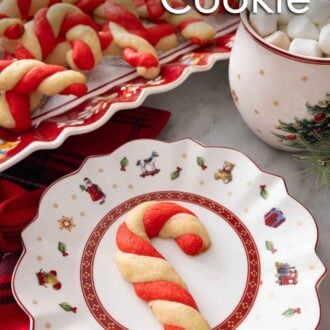 Pinterest graphic of a candy cane cookie on a plate in front of a platter.