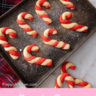 Pinterest graphic of a baking tray with multiple candy cane cookies.